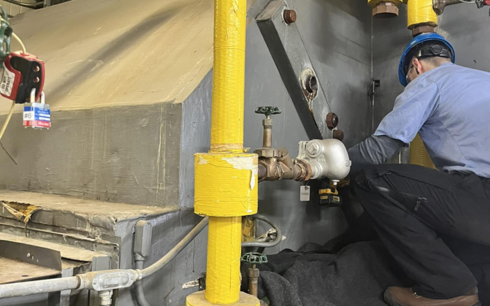 Man Working On Repairing Pipes In Hvac System