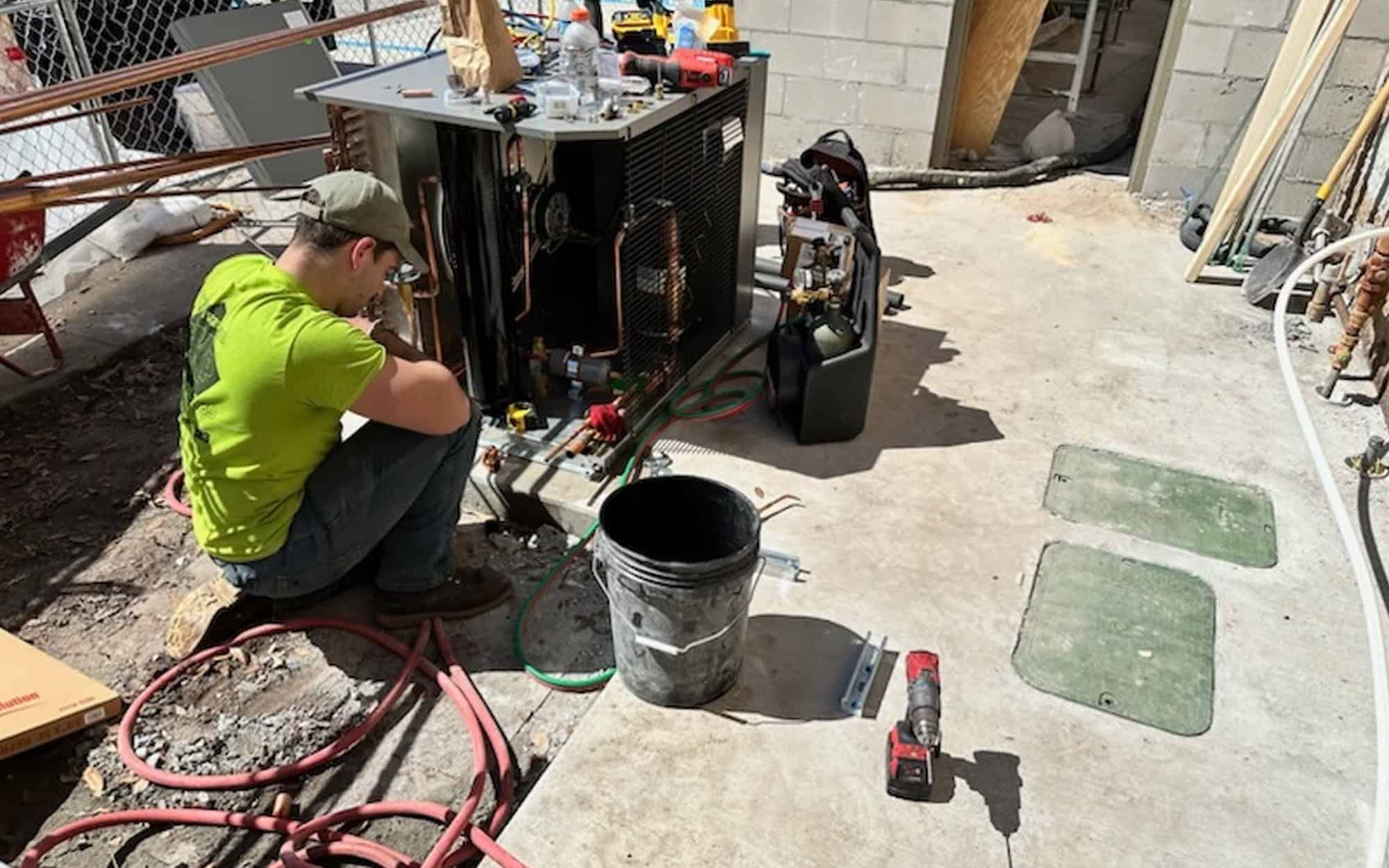 Worker Repairing Exterior Hvac System