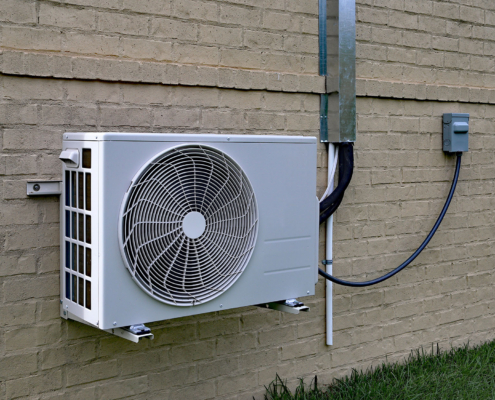 Air Conditioner Mini Split System Next To Home With Brick Wall